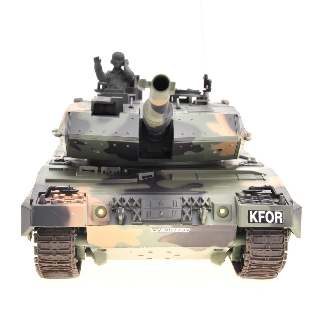 Camouflage tank model with a soldier figure on a white background