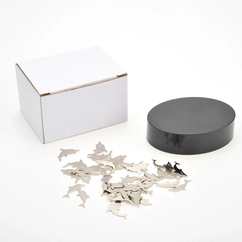 Magnetic dolphin sculpture desk toy with black platform and included box for stress relief and creativity enhancement.