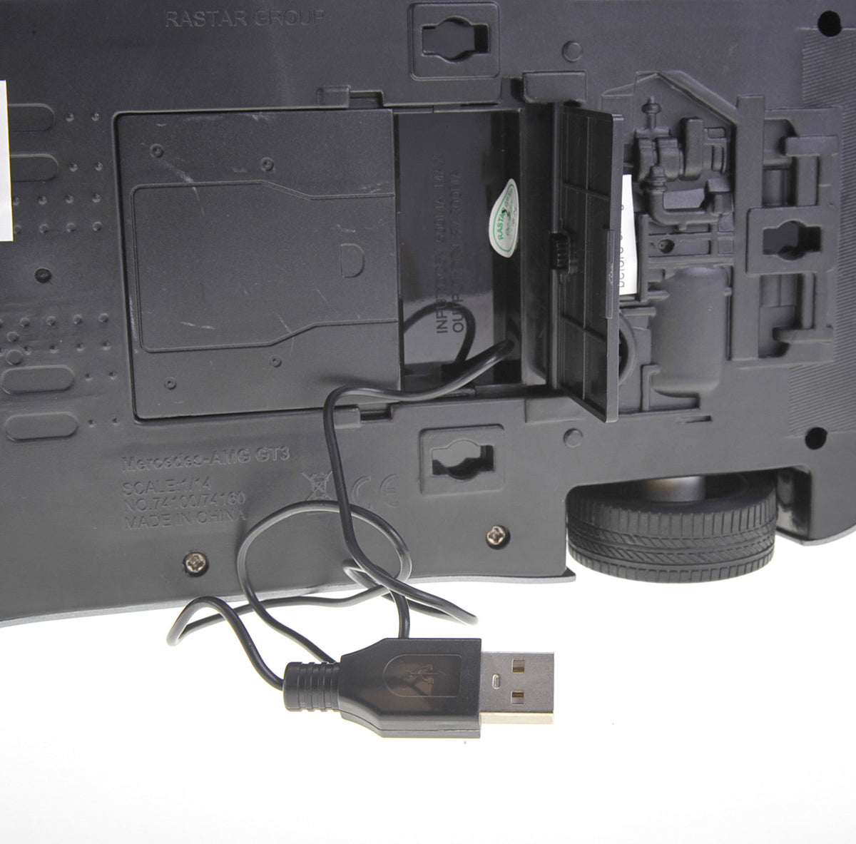 Close-up of a black electronic device with USB cable on a white background