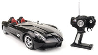 Black toy car with open top and remote control on a white background