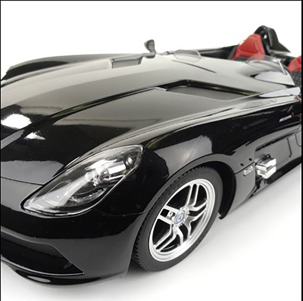 Black sports car with red interior on a white background