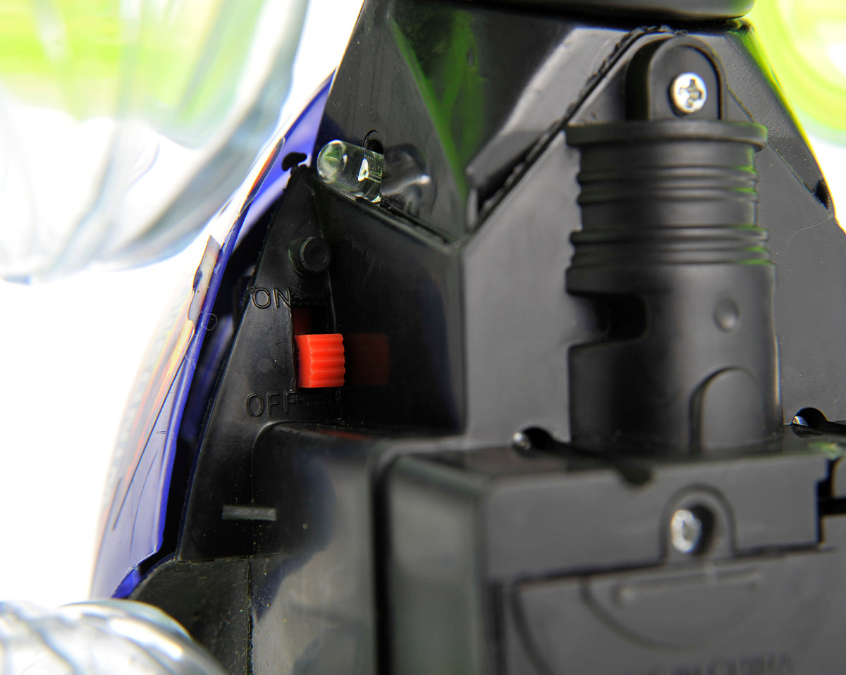 Close-up of a motorcycle headlight assembly with visible branding.