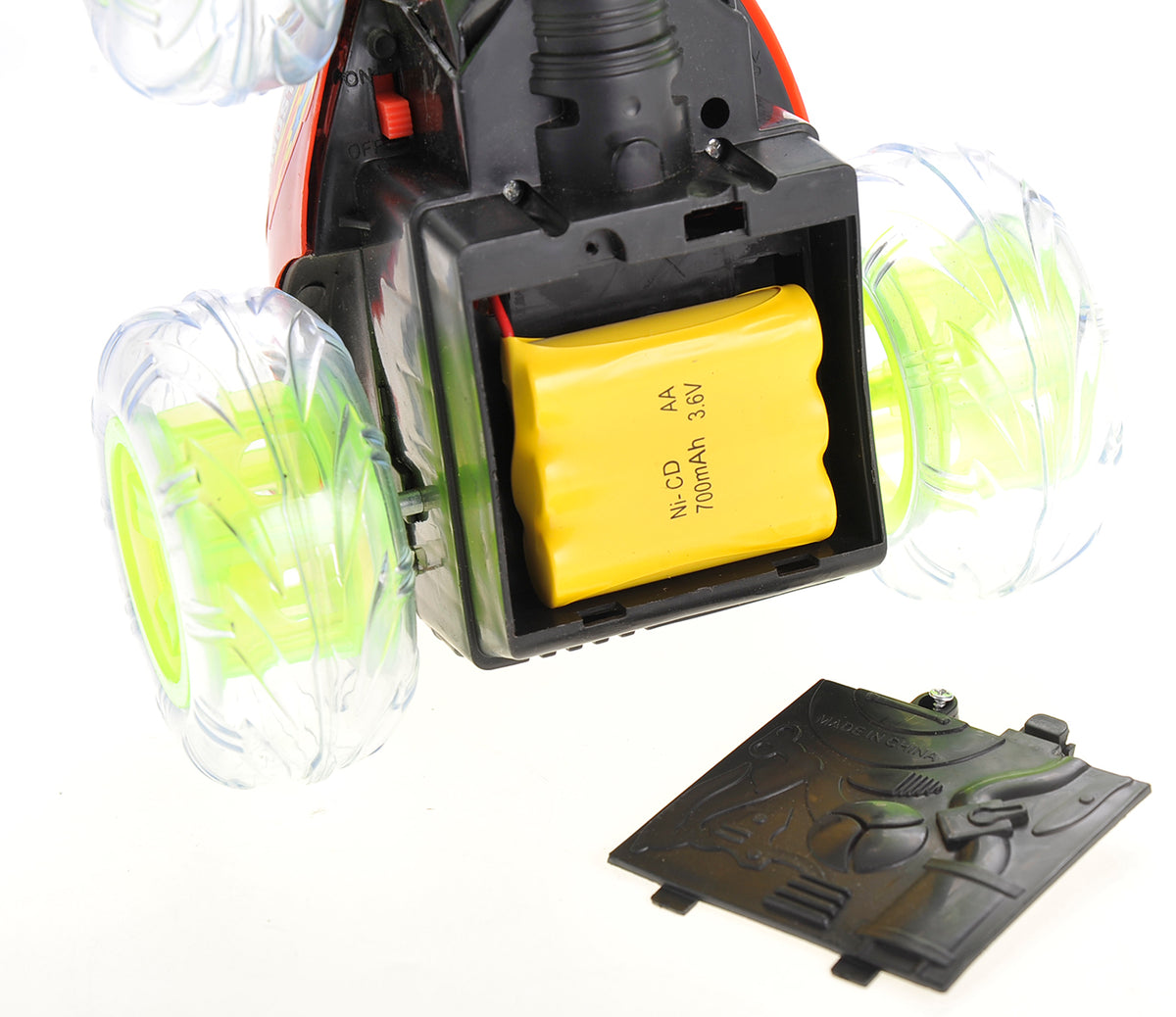 Close-up of a device with a yellow battery pack and transparent wheels on a white background