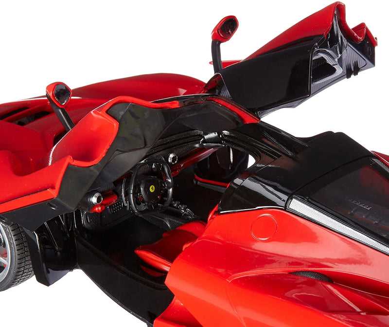 Close-up of a red and black sports car model with open doors on a white background