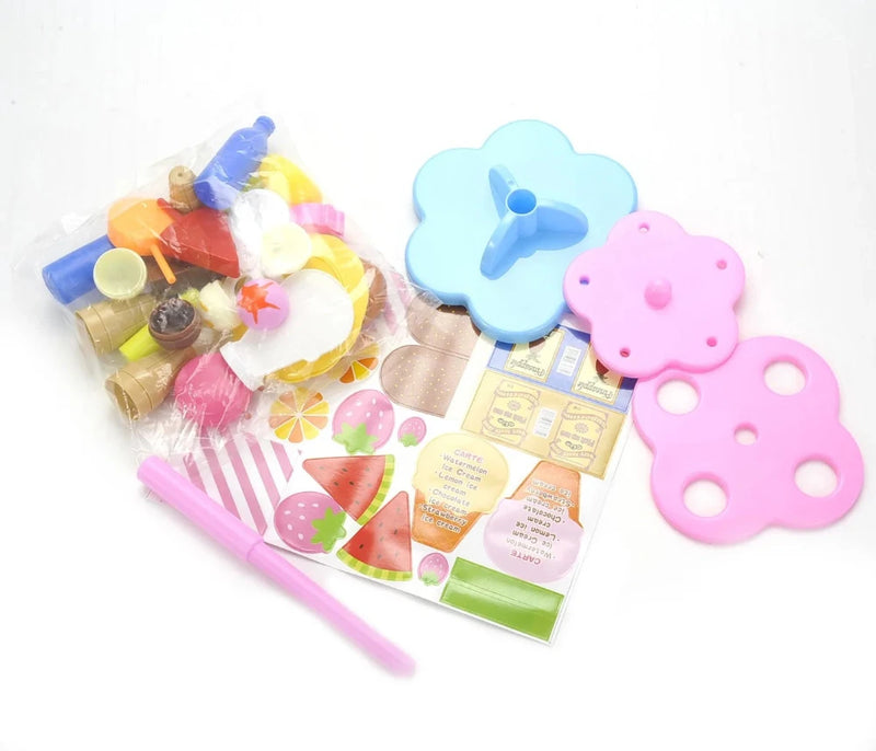 Components of the Play Desserts Ice Cream Set including bases, stickers, and dessert pieces for assembly