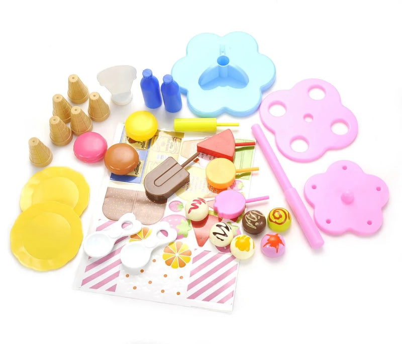 Unboxed Play Desserts Ice Cream Set showing cones, scoops, dessert toys, and assembly parts