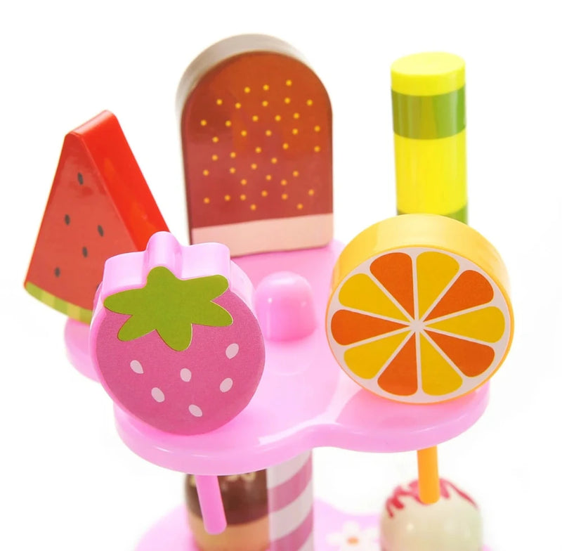 Close-up of fruit-shaped dessert toys including watermelon, strawberry, orange, and chocolate bar from the Play Desserts Ice Cream Se