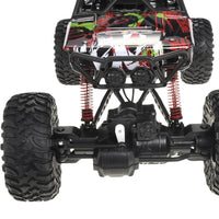 Closeup view of the rock crawler RC car with rugged tires and shock absorbers for rough terrains.