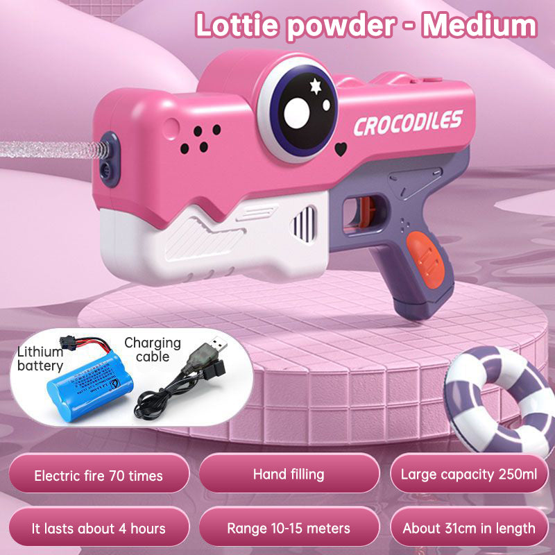 Pink toy gun labeled 'Crocodiles' with charging cable and battery on a pink background
