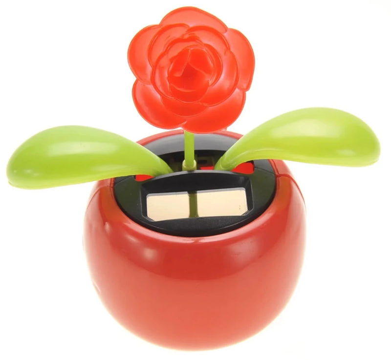 Close-up view of solar flower pot toy with green leaves and red flower, solar-powered and environmentally friendly.