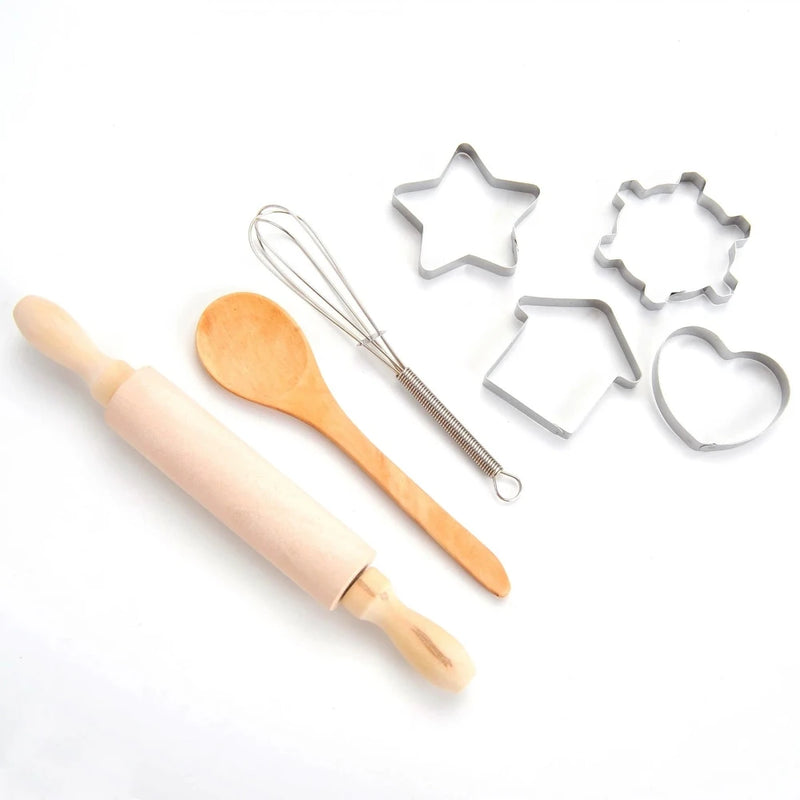 Toddler chef costume accessories including wooden spoon, whisk, rolling pin, and cookie cutters for pretend play