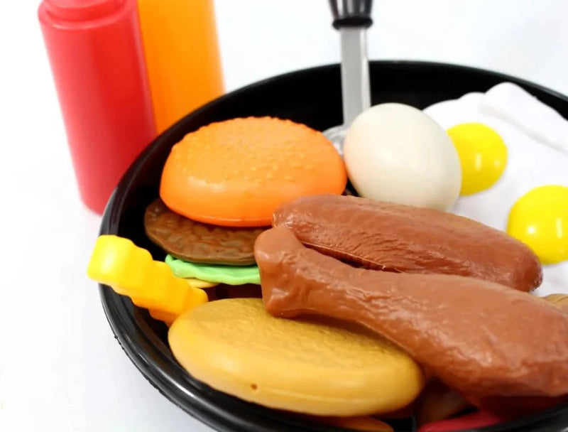Toy breakfast playset with plastic food items including chicken legs, burger, fries, and eggs in a pan, ideal for kids' pretend play kitchen.
