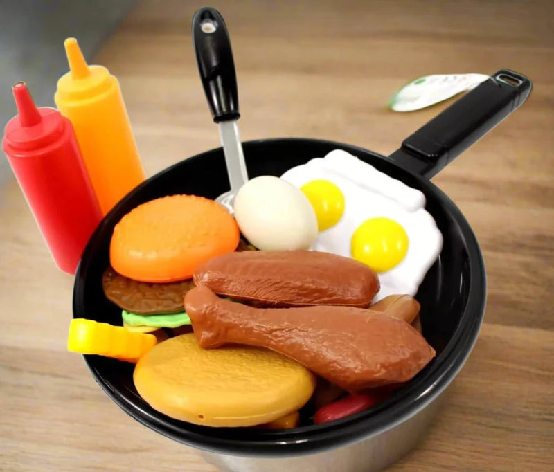 Toy food set with cooking pan, plastic fried eggs, chicken drumsticks, and condiments, designed for children's playtime cooking