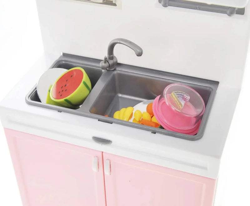 Toy kitchen sink with play food items and a dish cover.