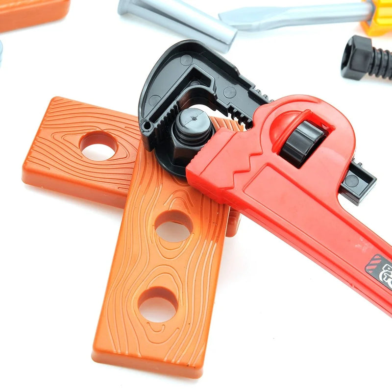 Toy pipe wrench interacting with a pretend wood block, from a handy manny tool box playset for kids