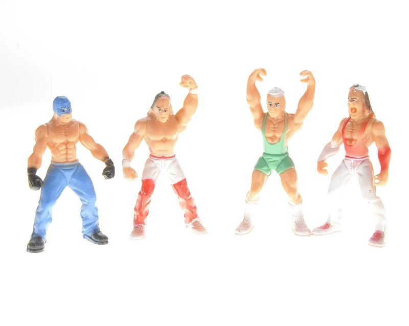 WWE wrestling ring playset with multiple action figures, barricades, and accessories for battle