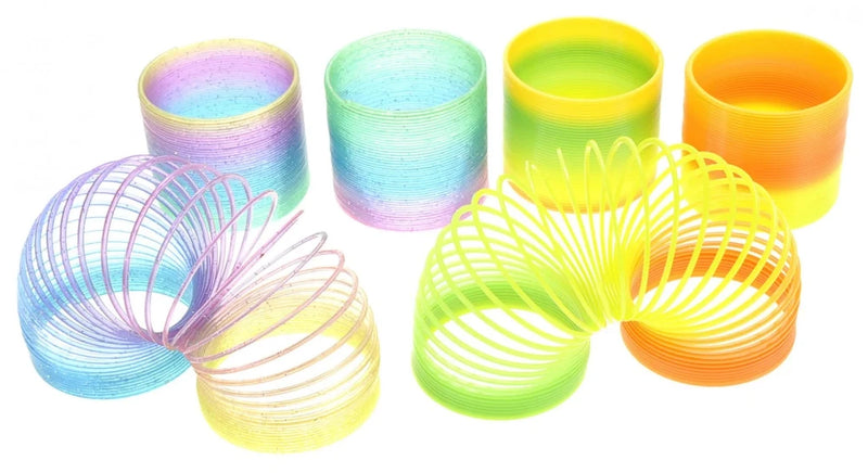 Bright yellow and green plastic rainbow magic spring in a mesmerizing arch, perfect for children's play.